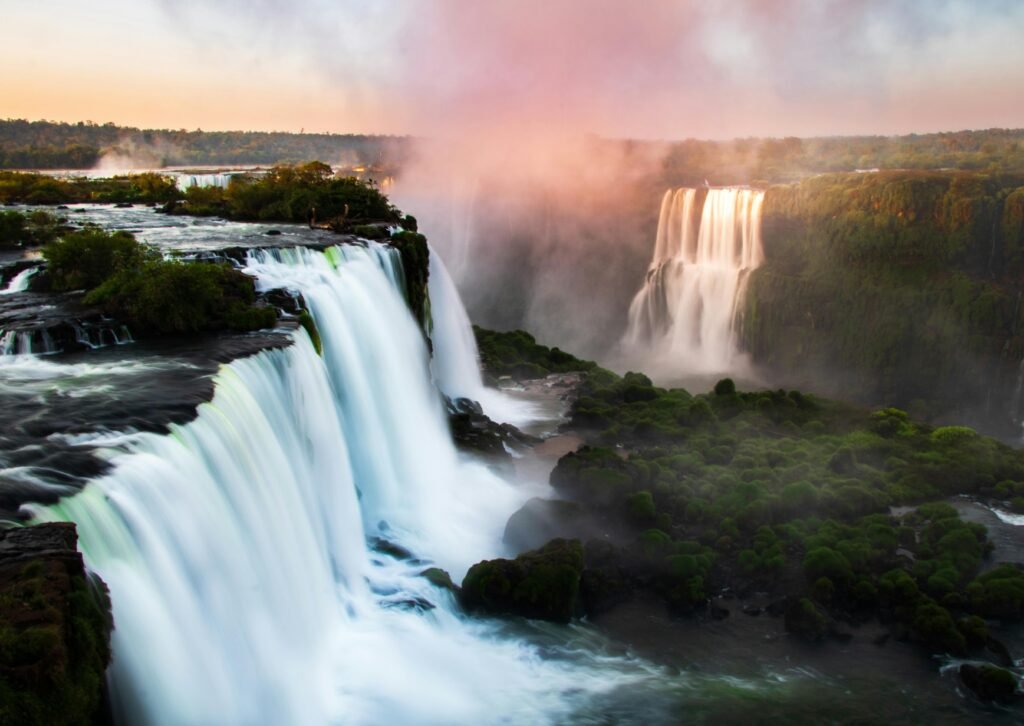 Stunning view of Iguazu Falls with cascading water and morning mist.