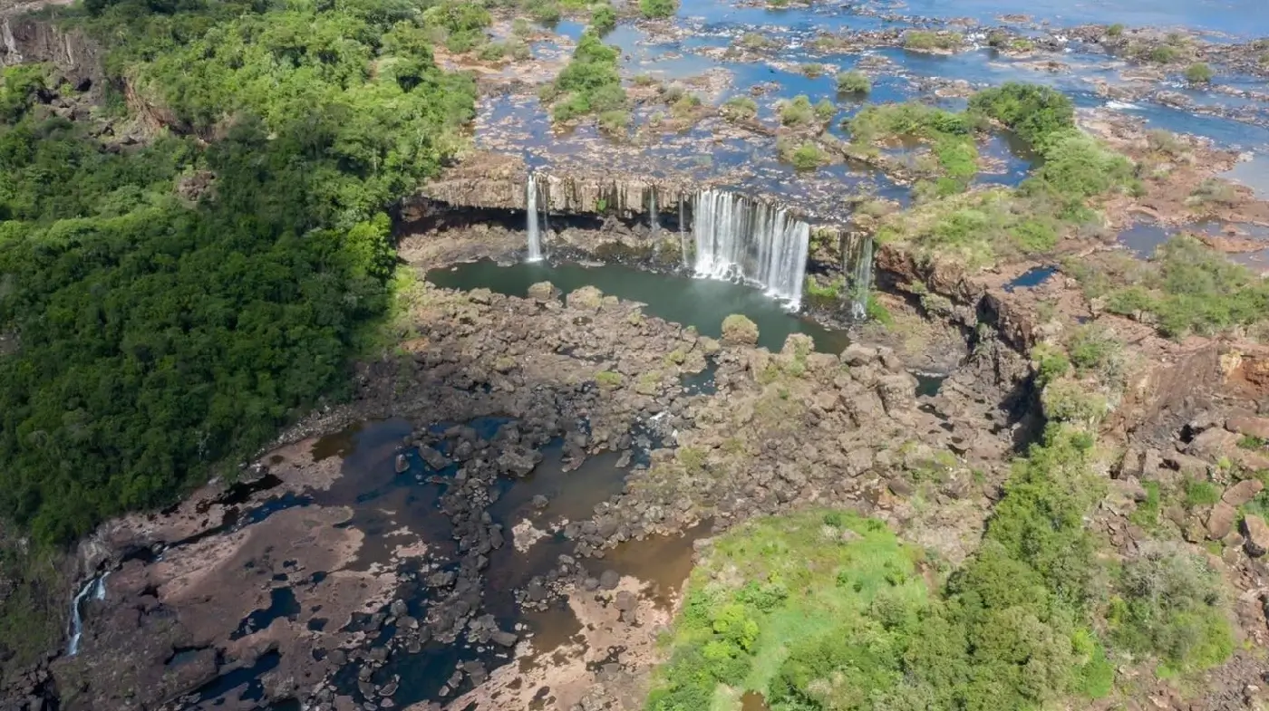 Aerial view of Iguazu Falls during the dry season, exposing the basalt rock bed and showing how the river has eroded it over time